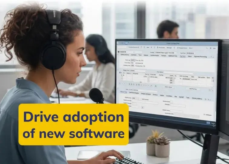 A woman with curly hair tied back wearing a headset sits at a desk, focused on a large computer monitor displaying a complex software interface. Other colleagues are visible working in the background of the office. A yellow text box overlaid on the image reads: 