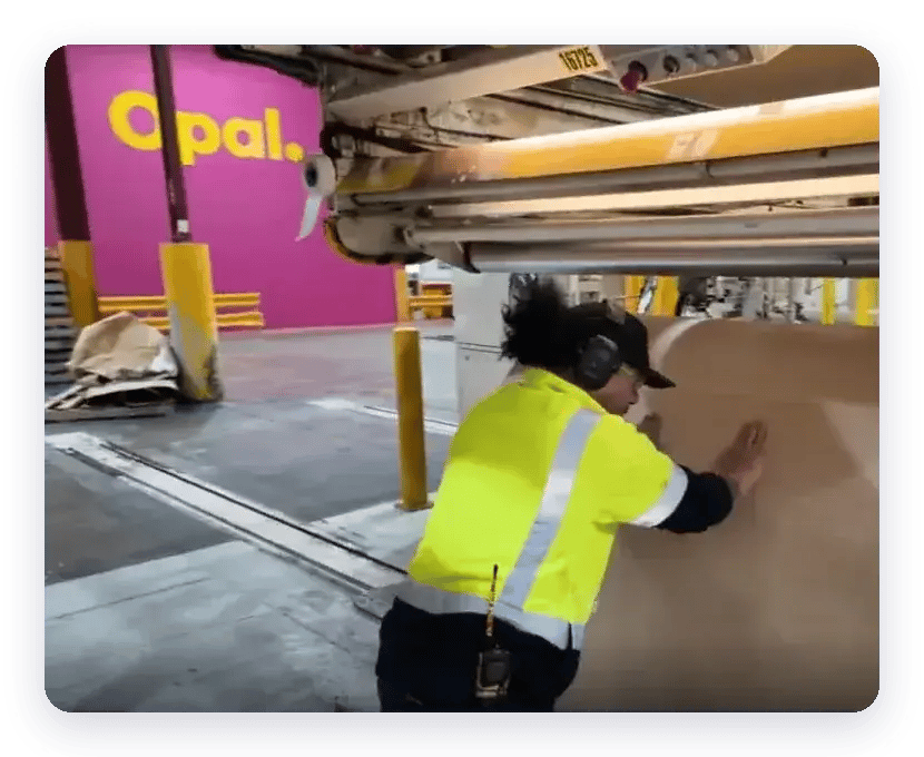 Opal operator guiding a paper reel in an Opal factory